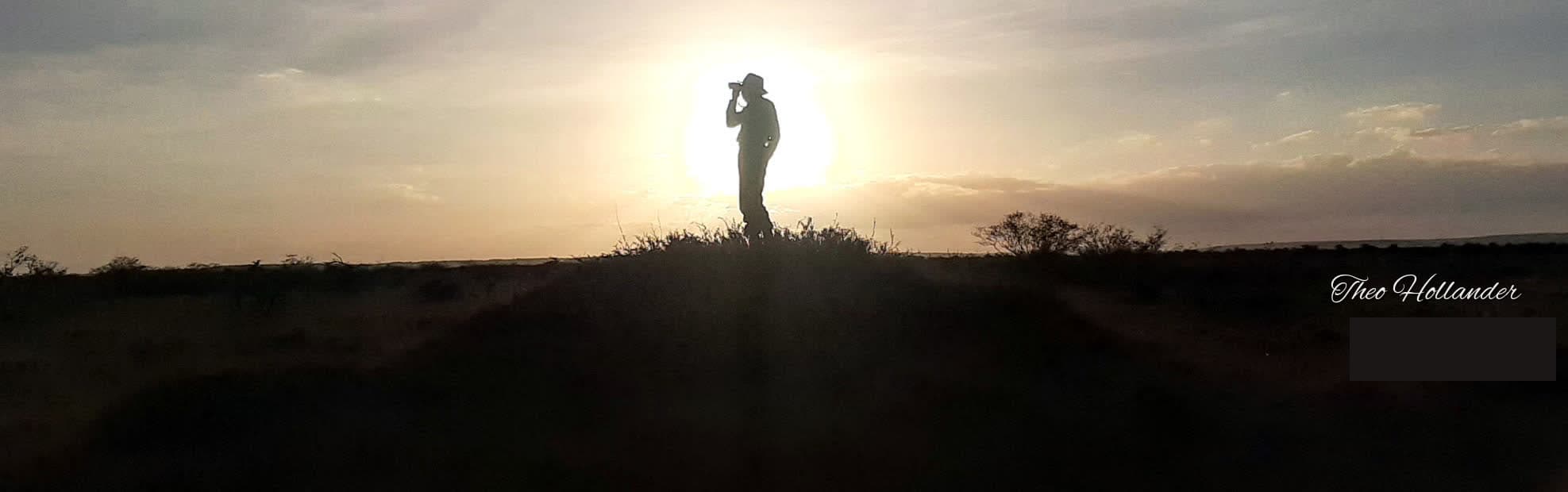 A guide spotting lions at sunset on Mugie Ranch
