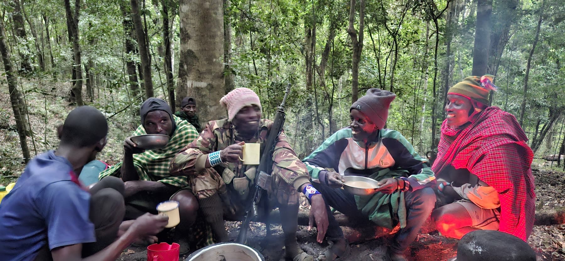 The crew sharing tea and porridge around the fire before the climb