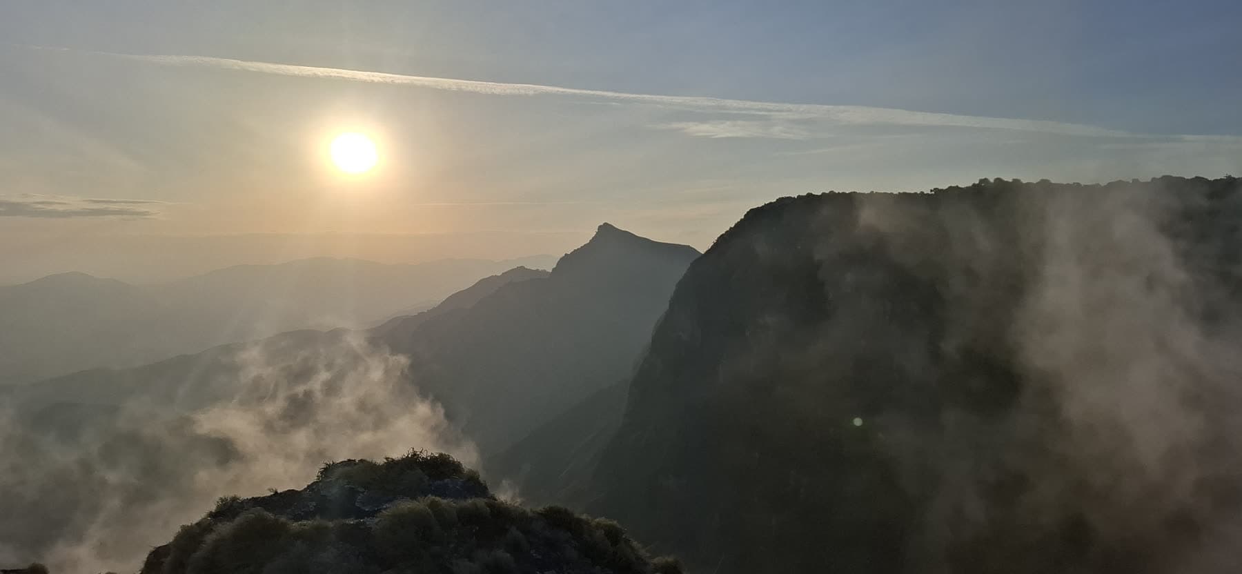 Sunrise breaking through mist over a Ndoto Mountains ridge