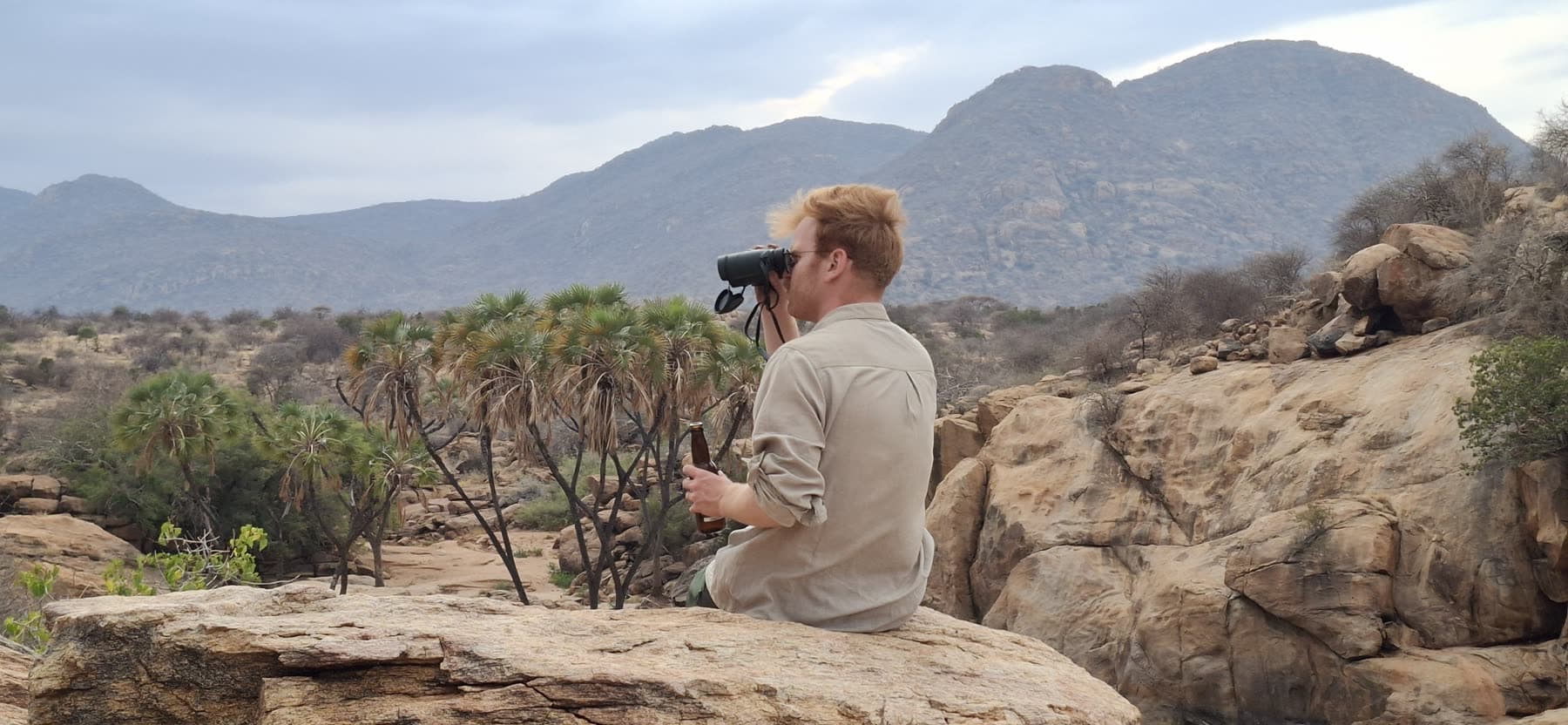Watching over the Shaba river valley with binoculars, beer in hand