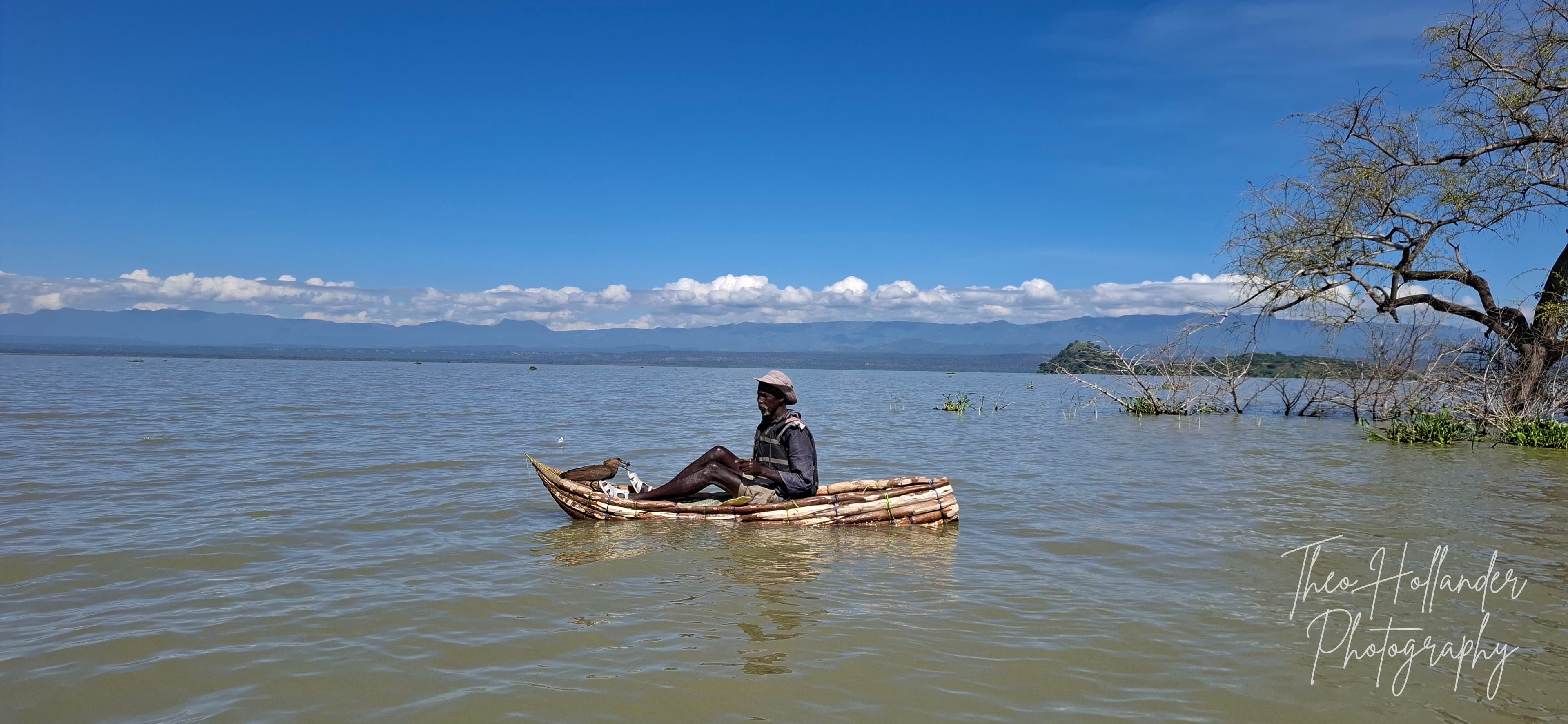 A fisherman paddling a traditional canoe on Lake Baringo