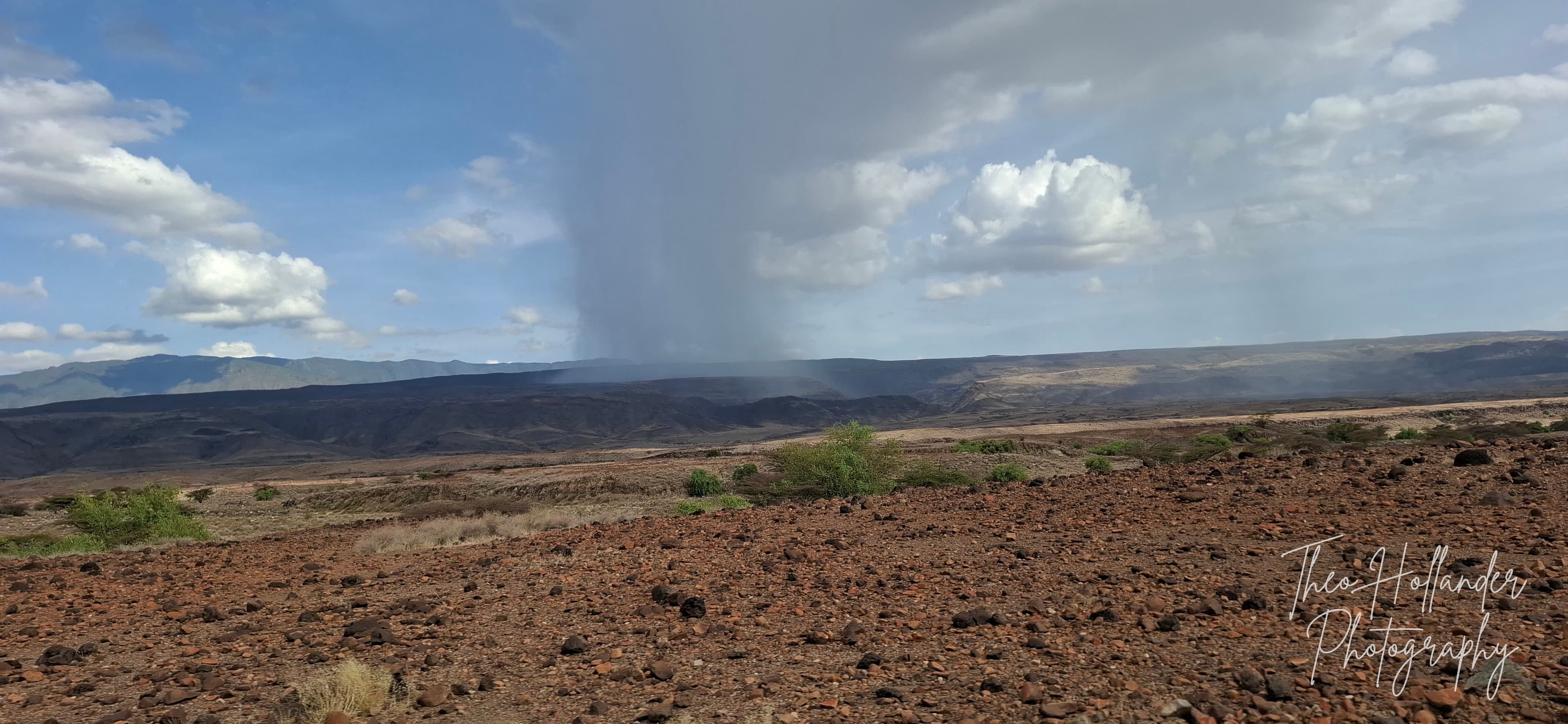 A rain shower sweeping across the vast floor of the Rift Valley