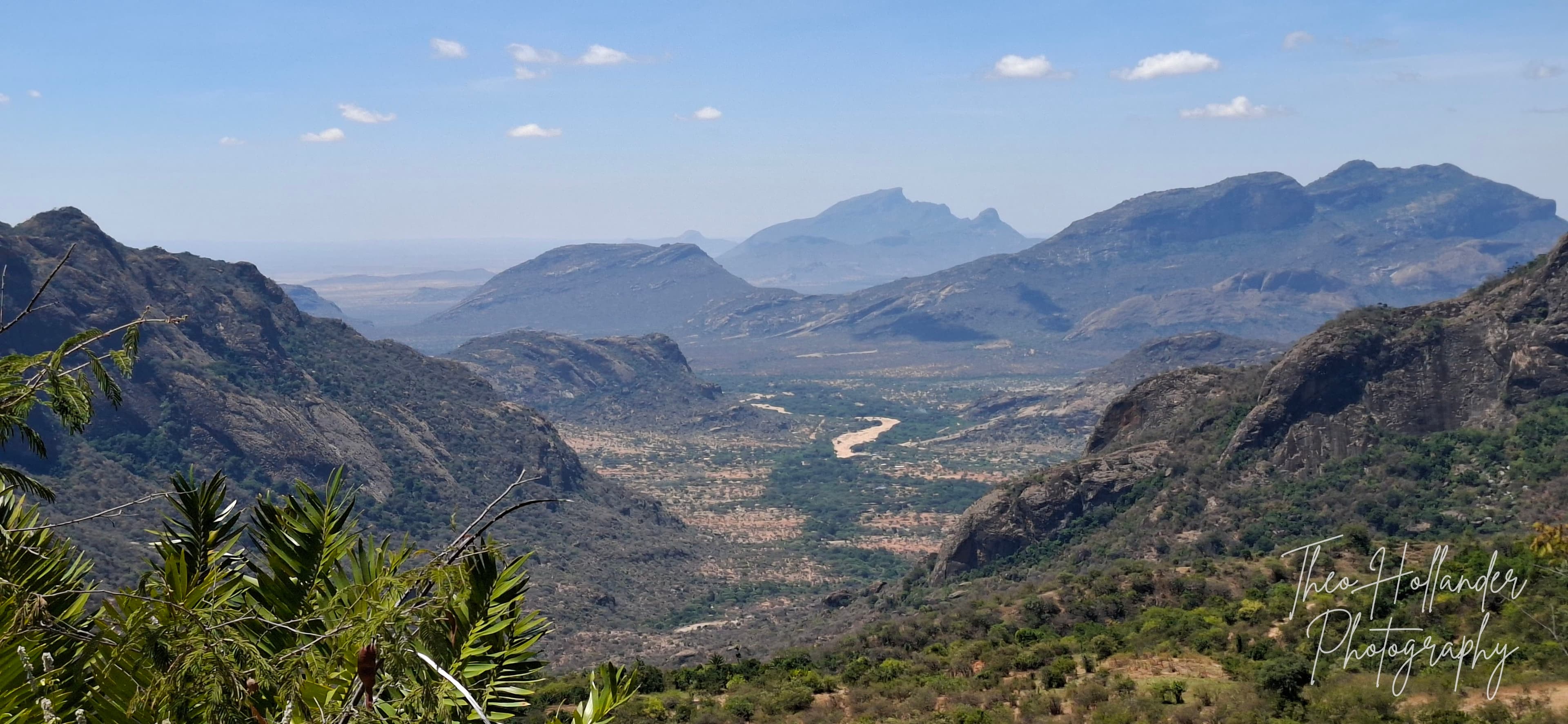 A wide valley view with a river winding far below